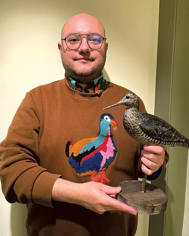 Kory Rogers with a shorebird carved by Charles Sumner Bunn - COURTESY OF KATE OWEN