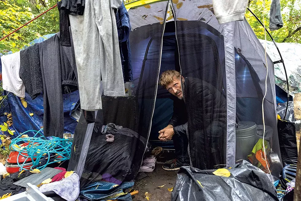 Carol's husband, Mitchell, in their tent - JAMES BUCK