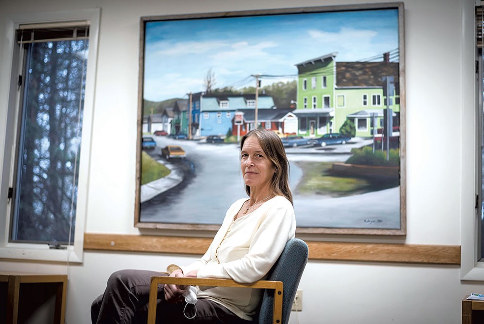 Dr. Laura Norris in front of a painting of Jeffersonville in the waiting room of Cambridge Family Practice - GLENN RUSSELL