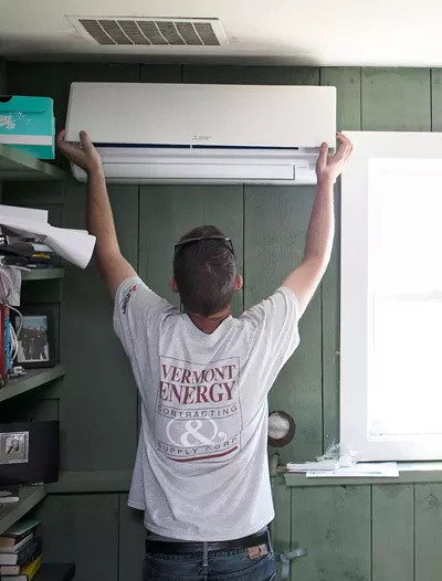 A contractor installing a heat pump register - COURTESY