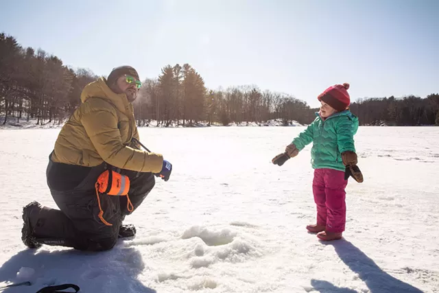Michael Santos lead the ice fishing clinic alongside assistant volunteer Joe Bartlett. - CAT CUTILLO