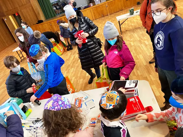 Preschool and Hebrew School families making kits for new Americans - COURTESY