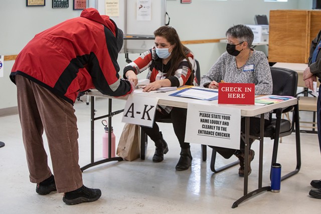 Checking in voters at the Miller Center in Burlington - LUKE AWTRY