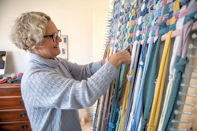 Julie Reville weaving on her handmade loom - DARIA BISHOP