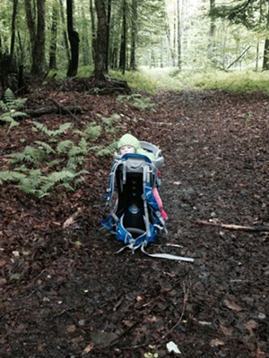 Elise keeps a safe distance while her parents clear a downed tree from a local trail. - TRISTAN VON DUNTZ