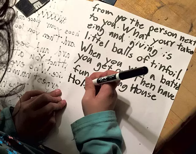 Cora writes game directions - COURTESY OF SARAH STEWART TAYLOR
