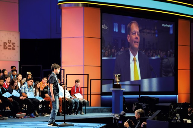 Dr. Jacques Bailly on the big screen at the 2018 Scripps National Spelling Bee - COURTESY OF MARK BOWEN/SCRIPPS NATIONAL SPELLING BEE