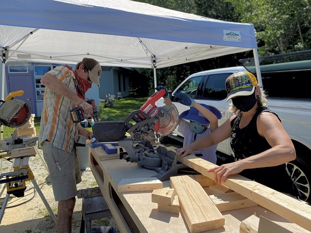 Volunteers cutting wood for convertible desk-benches - COURTESY OF LAKE CHAMPLAIN WALDORF SCHOOL
