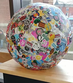 Courtesy of Fletcher Free Library - THE WORLD'S LARGES STICKER BALL, ON LOAN FROM STICKY BRAND