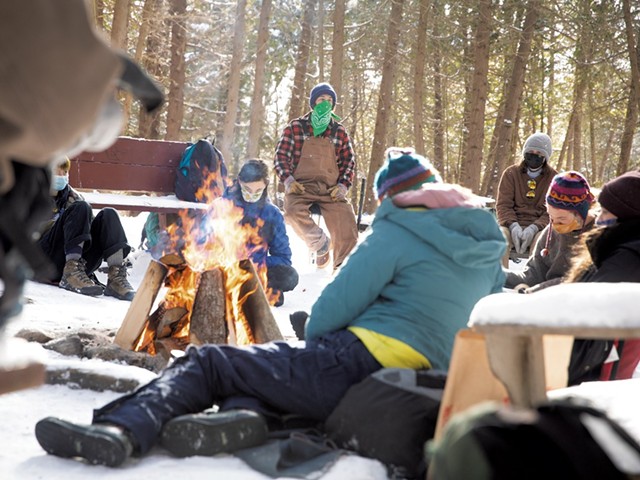 Students keeping warm at the Walden Cedar Grove, the program's base camp - CAT CUTILLO