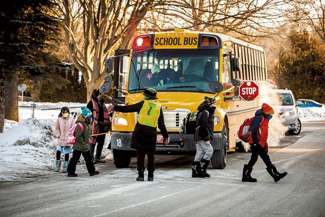 Elementary students exiting the school bus - CAT CUTILLO