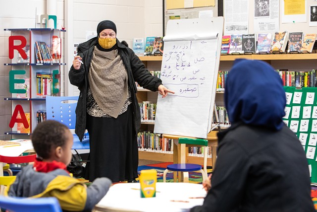 Mona Tolba teaches Arabic-English bilingual story time at Winooski Memorial Library while Zahra Mohamed and her son, Khalid, attend the event. - CAT CUTILLO