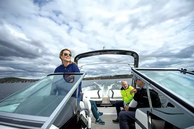 Champlain Fleet Club owners Tricia (captain) and Phil Scott (front right) cruising on Lake Champlain in Colchester with passengers - DARIA BISHOP