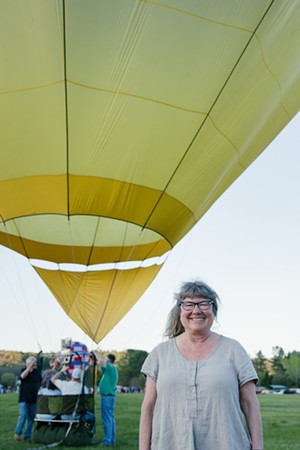 Tina Foster in front of a hot-air balloon at the Post Mills Airport - EMILY POGOZELSKI
