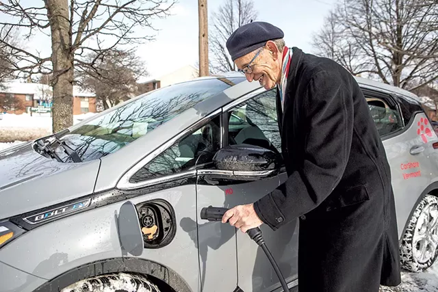 Stephen Yurasits charging an EV in Burlington - LUKE AWTRY