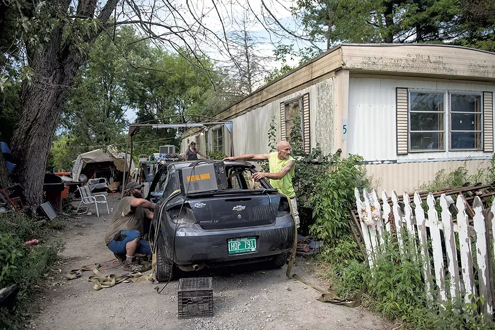 Mitchell Matteson (right) assisting his neighbor Chuck Delaney with a car project - DARIA BISHOP