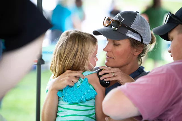 Eliza Leeper holds a vibrating Buzzy bee up to her 6-year-old daughter, Josie's, arm to help disperse any pain. - CAT CUTILLO