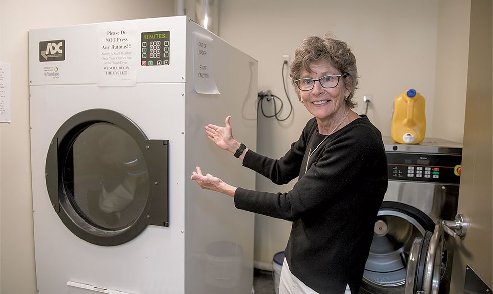 Markley showing off the new washer and dryer at COTS - DARIA BISHOP