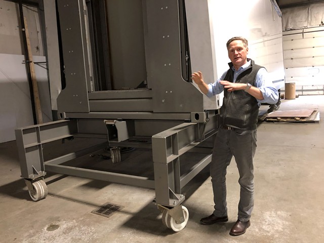 Tenfold Engineering owner David Jaacks with a prototype of the folding modular structures he hopes to start building this year.  - ANNE WALLACE ALLEN ©️ SEVEN DAYS