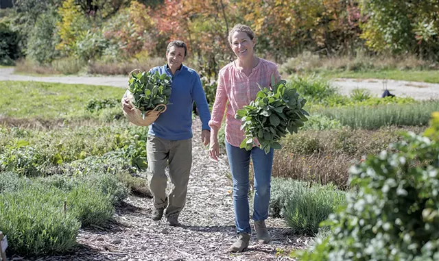 Tim and Becca Lindenmeyr with freshly harvested sage in their herb and flower gardens - DARIA BISHOP