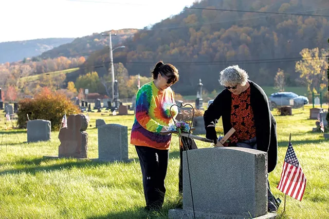 Kelli Lewis and Debbie Baker tending to a grave site - CHRISTINE GLADE