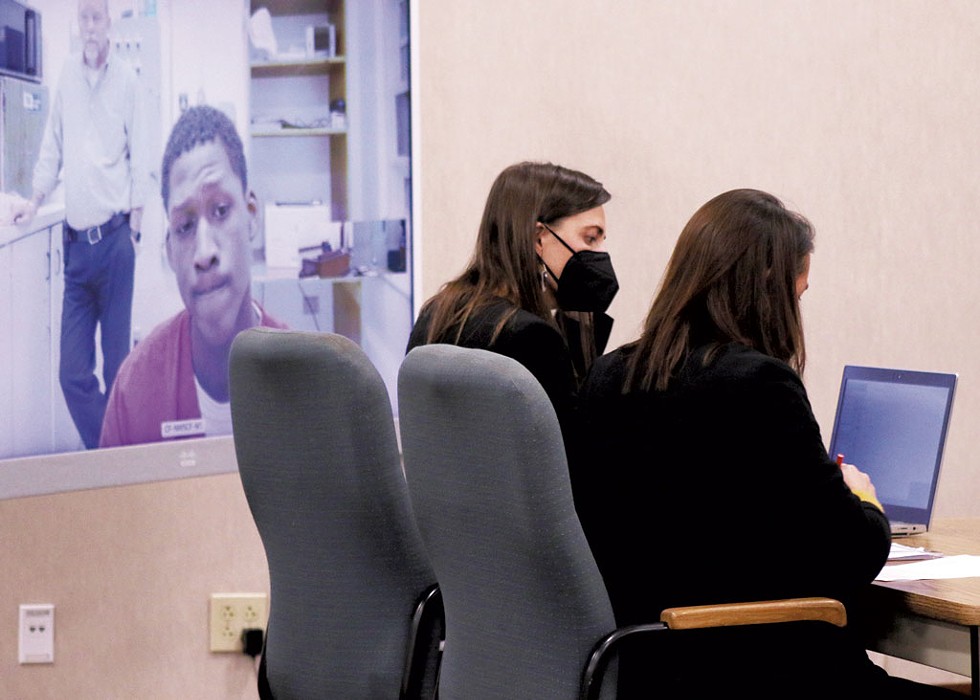 Abdiaziz Abdhikadir appeared via teleconference at his arraignment last week. Seated: deputy state's attorney Sally Adams (left) and Chittenden County State's Attorney Sarah George - COURTNEY LAMDIN ©️ SEVEN DAYS