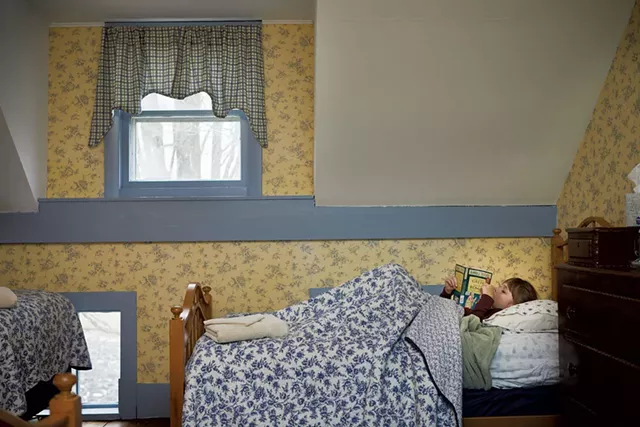 A young guest reading in bed - COURTESY OF JESSICA SIPE