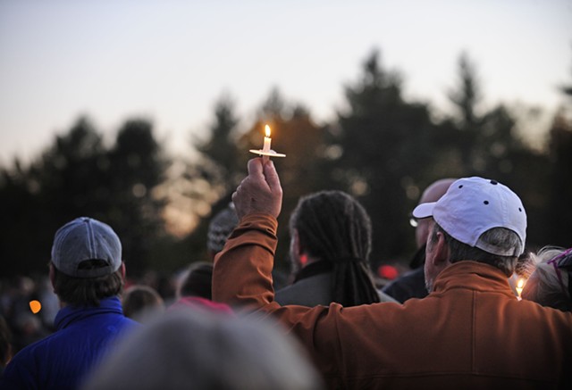 Holding a candle aloft at the vigil - STEFAN HARD