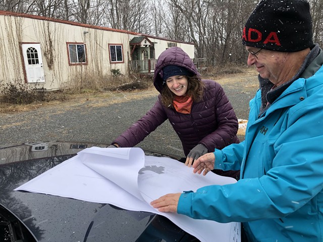 Eva Loomis, executive director of Upper Valley Habitat for Humanity, and board member Andrew Grimson reviewing blueprints for multifamily housing to be built in Weathersfield - ANNE WALLACE ALLEN