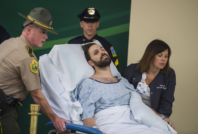 Steven Bourgoin is wheeled into his arraignment at the UVM Medical Center Friday morning. - GLENN RUSSELL/BURLINGTON FREE PRESS