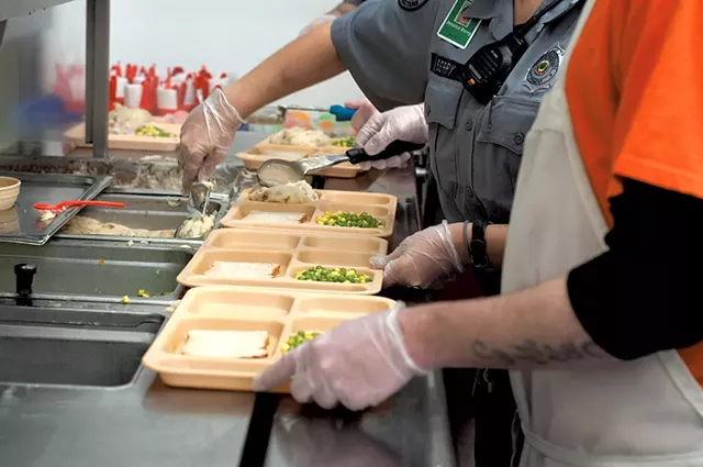 Preparing trays at Northeast Regional Correctional Facility - HANNAH PALMER EGAN