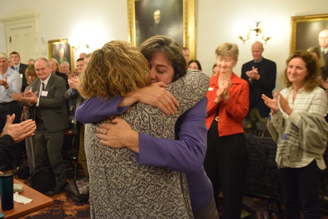 Reps. Mitzi Johnson, in purple, and Sarah Copeland Hanzas hug after Johnson won the vote to be the Democrats’ nominee for House speaker. - TERRI HALLENBECK