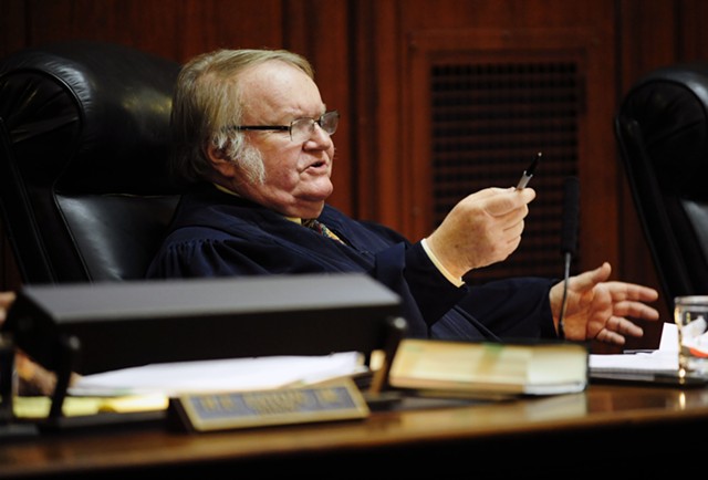 Justice John Dooley weighs in during Tuesday’s hearing about appointing his replacement. - STEFAN HARD