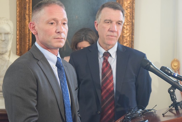 Commerce Secretary Michael Schirling (left) and Gov. Phil Scott talk Tuesday about the proposed agency reorganization. - TERRI HALLENBECK