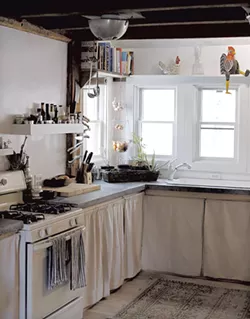 Hopkins and Meyerrose's remodeled kitchen features concrete countertops and a colander light fixture - SARAH PRIESTAP