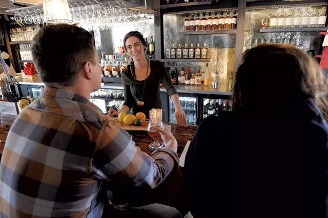 Emily Hassard visiting with bar customers - JEB WALLACE-BRODEUR
