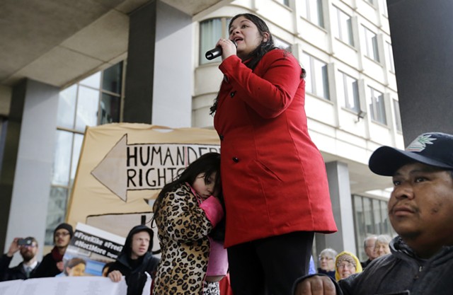 Lymarie Deida holds her daughter, Solmarie Carrillo, as she speaks about her husband, Alex Carrillo, at a rally outside a Boston court on Monday. - ELISE AMENDOLA/AP