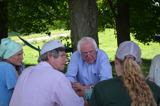 Sen. Bernie Sanders talks with dairy farmers in East Fairfield. - ALICIA FREESE