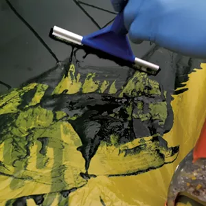 Straining spirulina with squeegee. - SALLY POLLAK