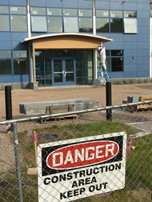 Construction fencing around the nearly complete building - MATTHEW ROY