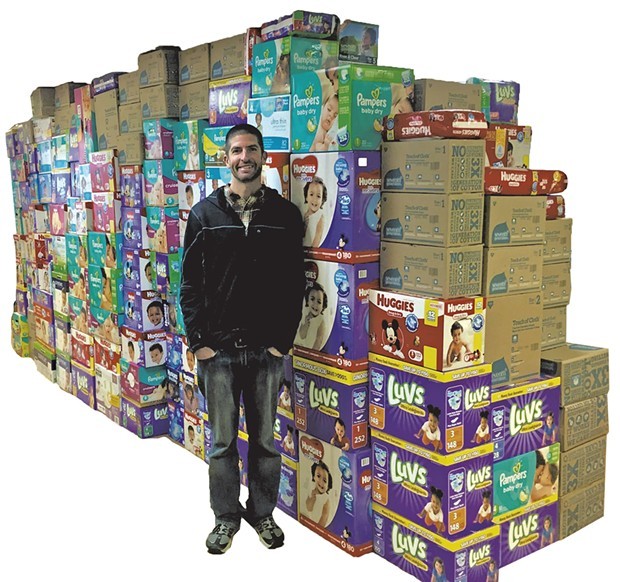 Fitzgerald in front of the wall of diapers - COURTESY OF DEE PHYSICAL THERAPY