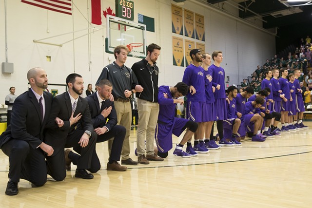 Multiple St. Michael's players kneeled at Saturday's game, as did coach Josh Meyer (far left). - JAMES BUCK