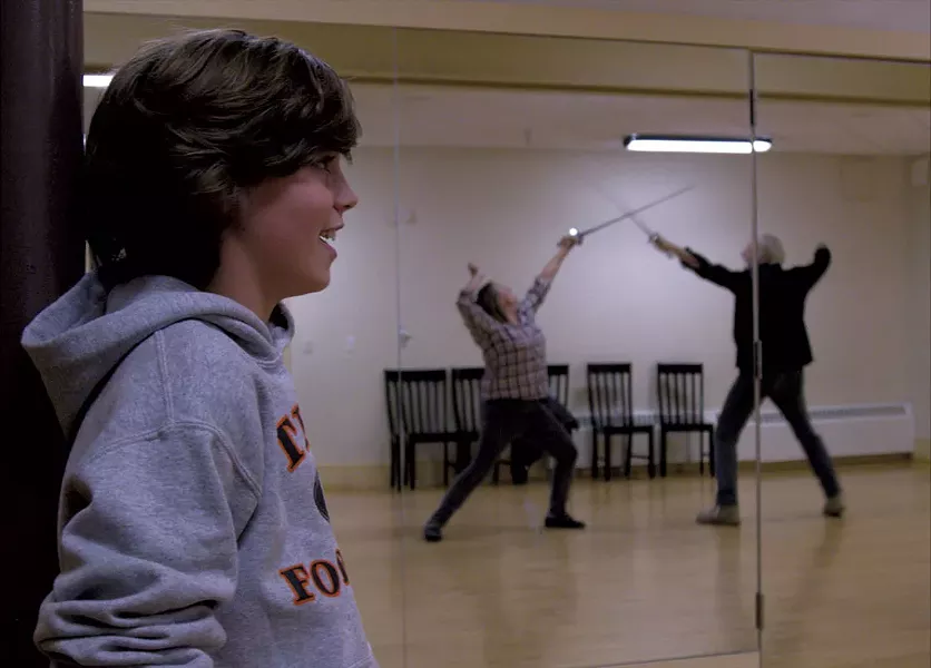 George Delvin watching Lindsay Pontius and Paul Schnabel demonstrate sword fighting - COURTESY OF CRAIG MARAVICH