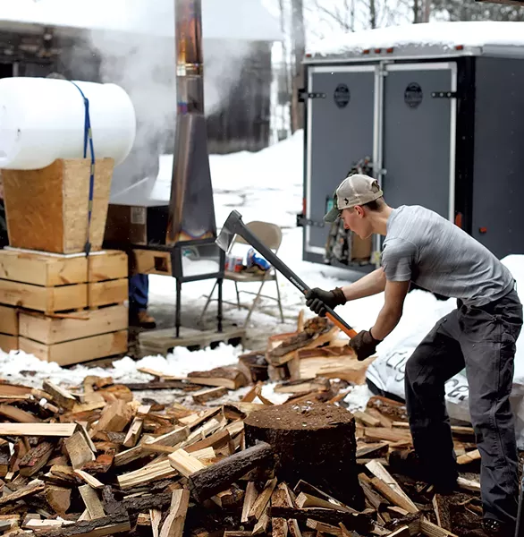 Student chopping wood - SARAH PREISTAP