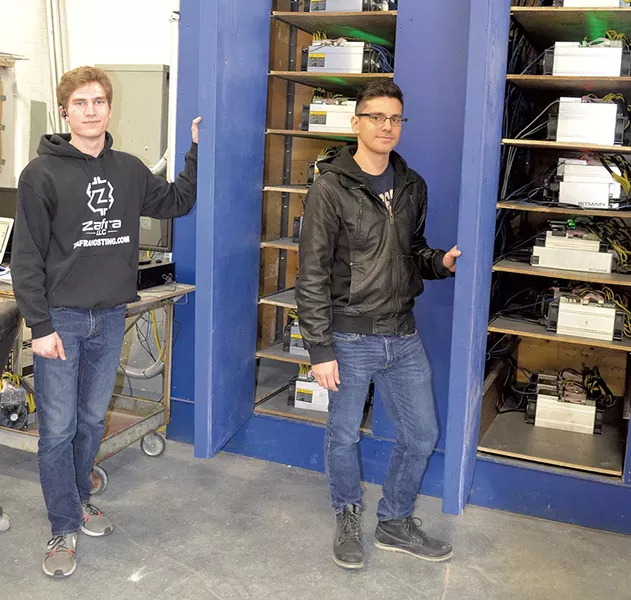 Ryan Brienza (left) and David Bowman with Bitcoin mining machines - MOLLY WALSH