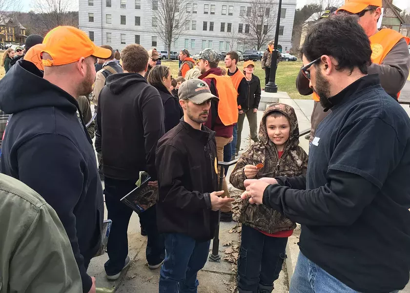 RECOIL Magazine executive director Rob Curtis handing out free 30-round magazines, - JOHN WALTERS