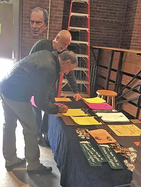 Bert Saldi looking on as Gov. Phil Scott signs a gun-rights letter in February 2017 - COURTESY OF DEVON CRAIG