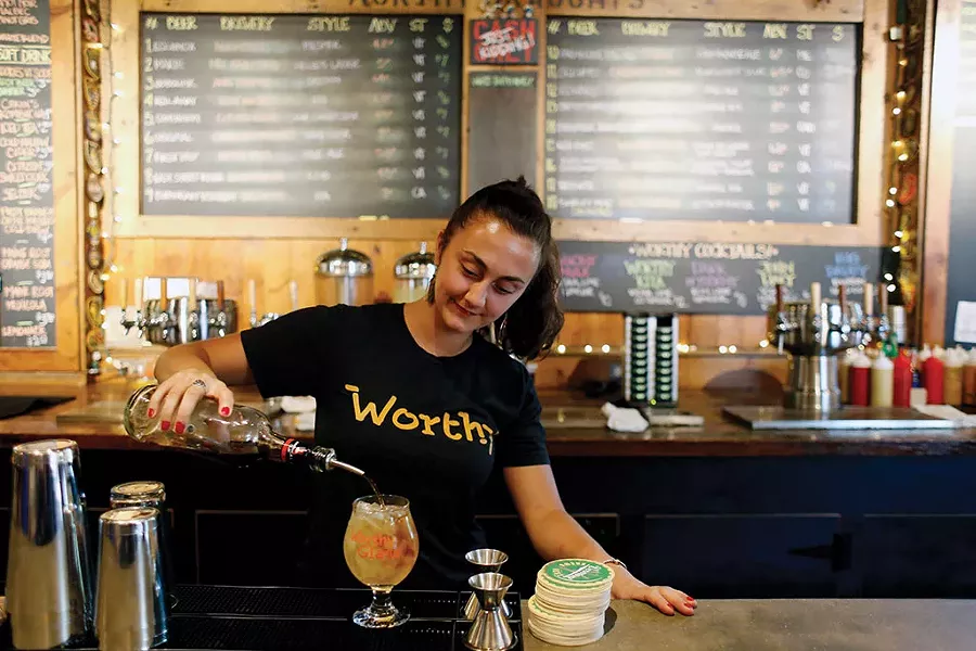 Bartender making a dark and stormy - SARAH PRIESTAP
