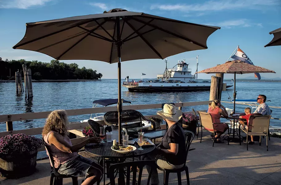Patrons on the deck of the Old Dock Restaurant & Marina watching the arrival of the ferry - GLENN RUSSELL