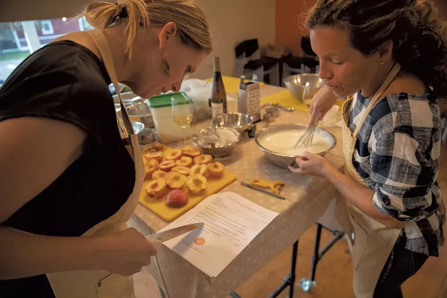 Students preparing peaches for dessert at a Richmond Community Kitchen class - JAMES BUCK